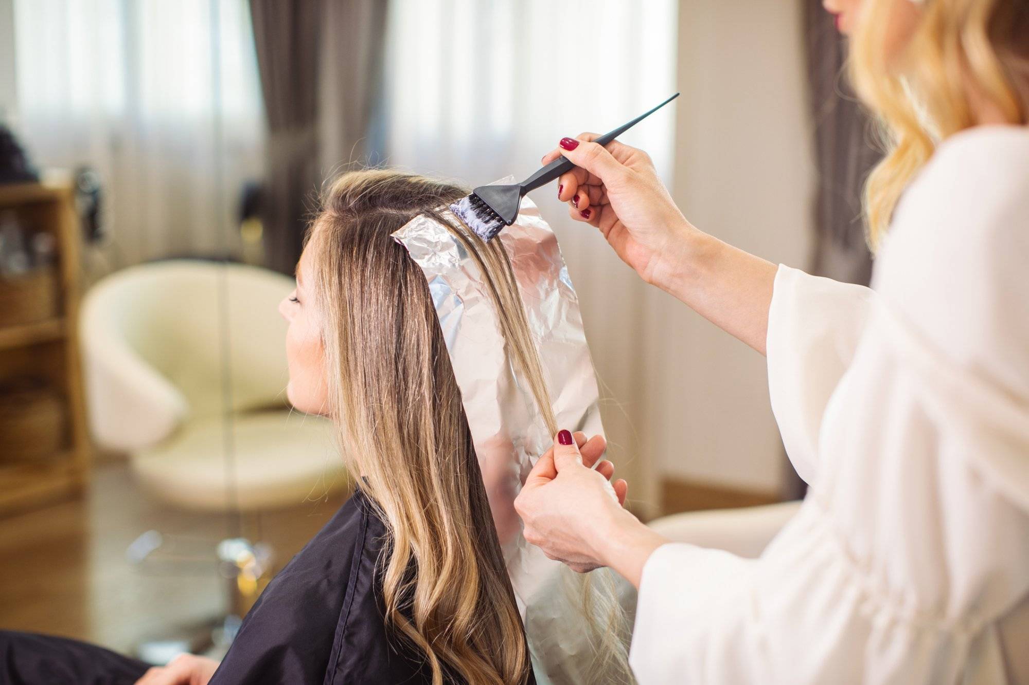 Woman dyeing her hair at the salon