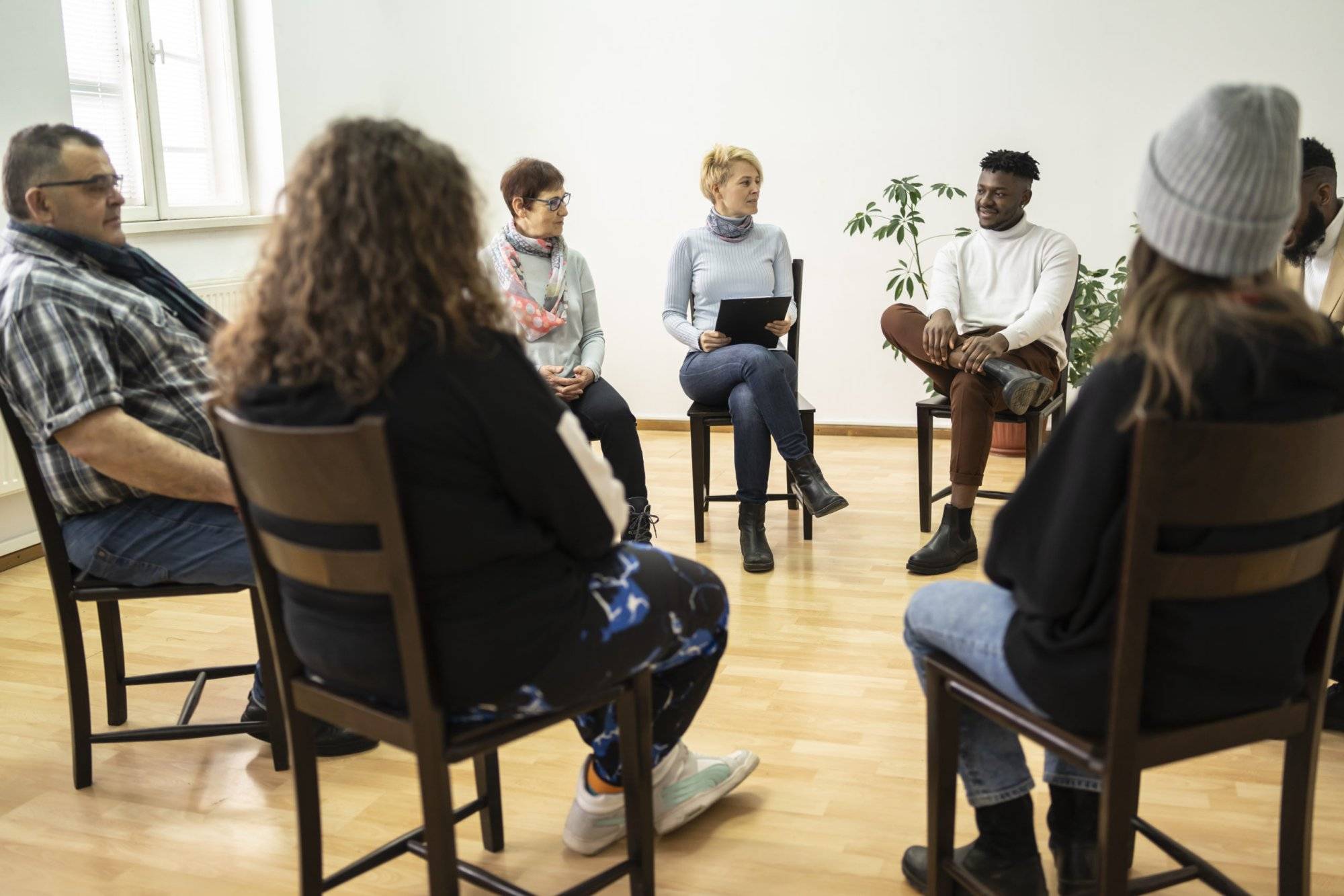 Group therapy support meeting talking about their mental health