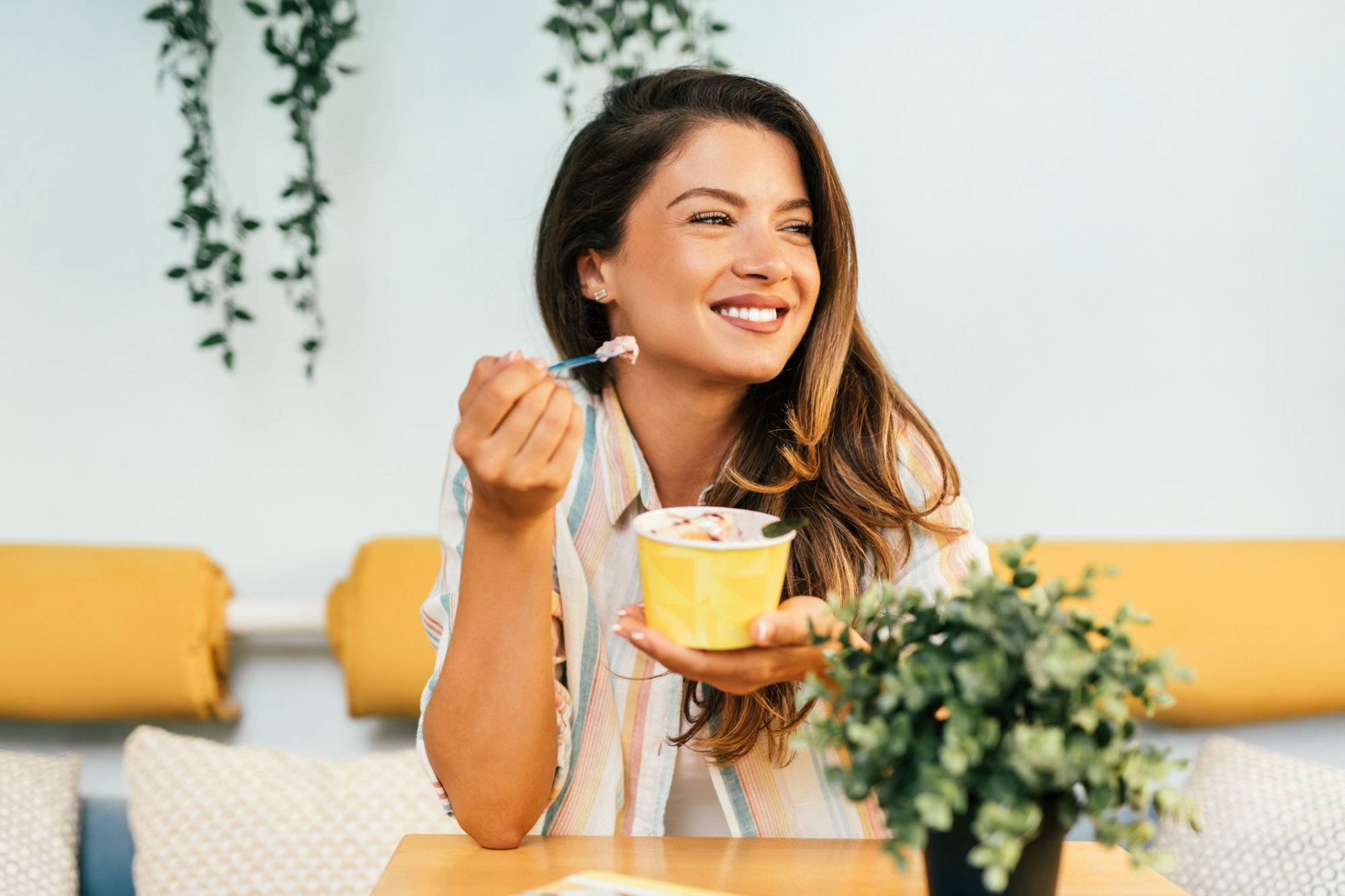 Happy young woman enjoying in rolled ice cream Happy young woman enjoying in rolled ice cream