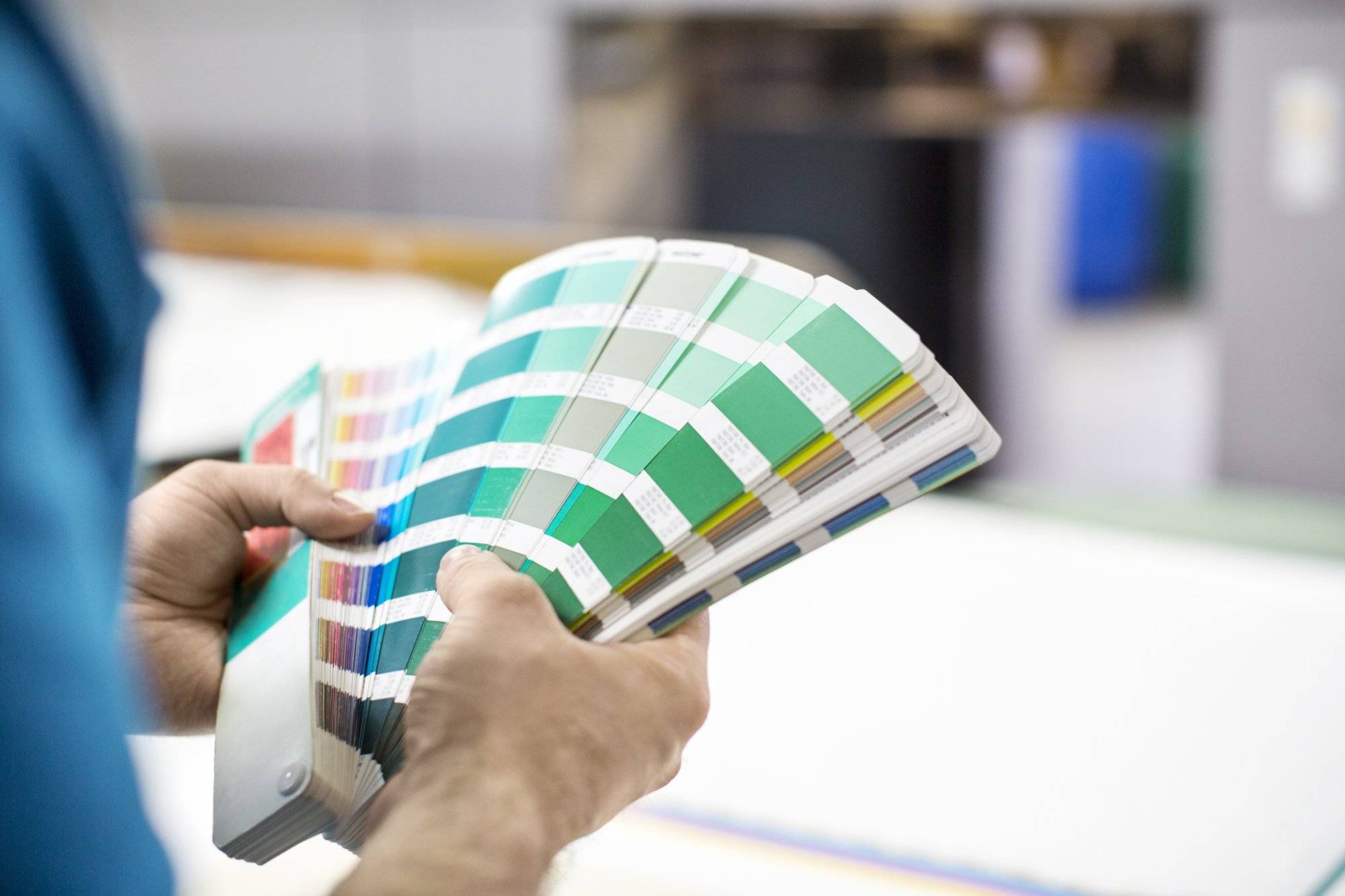 Man hands with colour samples at printing press Man hands with colour samples at printing press
